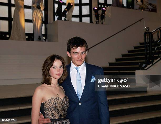 British actress Felicility Jones arrives with her co-star Rupert Friend at the British Premiere of their latest film ' Cheri' at the French...