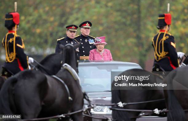 Queen Elizabeth II, accompanied by Major General Matthew Sykes and Lieutenant General Sir Andrew Gregory , stands in her State Review Range Rover to...