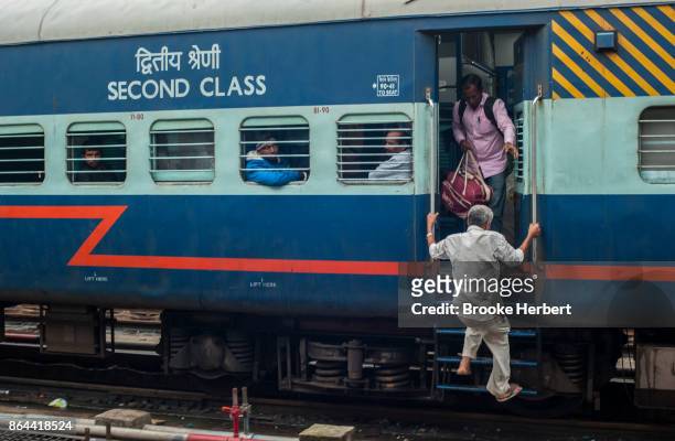 Passengers rush to board an Indian Railways train car that arrived late on Monday, during Diwali week on October 16 in Bangalore, India. Diwali, the...