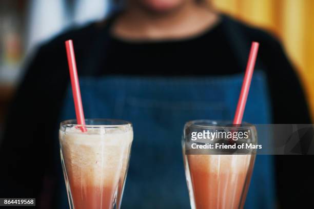 two chocolate milkshakes with bright pink straws - chocolate milkshake stock pictures, royalty-free photos & images