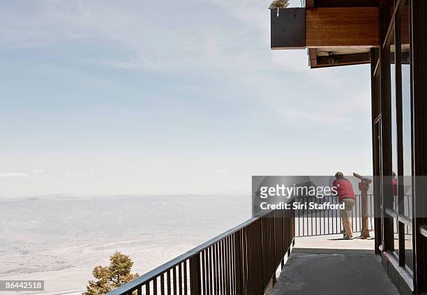 man standing next to binoculars at vista overlook - coachella valley stock pictures, royalty-free photos & images