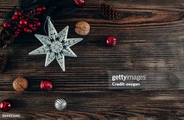 christmas decoration star on dark wooden background - blue wooden table stock-fotos und bilder