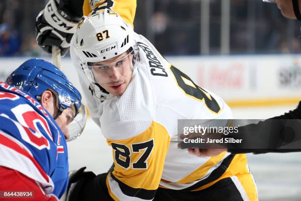 Sidney Crosby of the Pittsburgh Penguins takes a face-off against Adam Cracknell of the New York Rangers at Madison Square Garden on October 17, 2017...