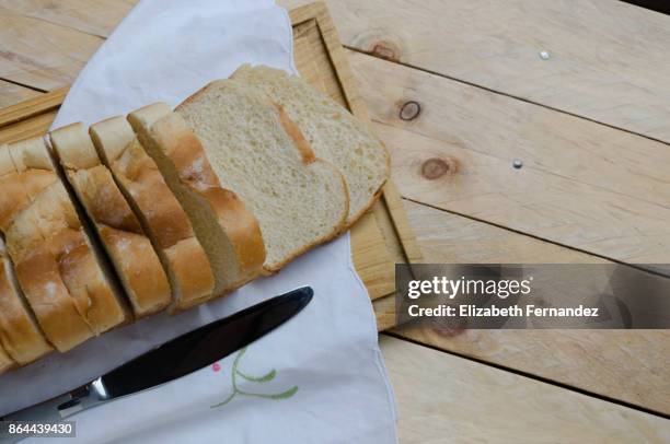 loaf of sliced bread on a chopping board - sliced white bread isolated stock pictures, royalty-free photos & images