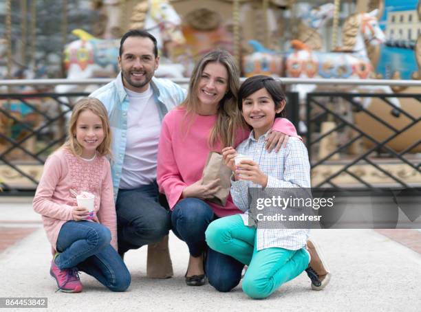 gelukkige familie plezier op een eerlijke carnaval - famous family funfair stockfoto's en -beelden