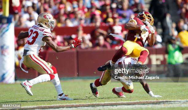 Jimmie Ward of the San Francisco 49ers upends Ryan Grant of the Washington Redskins during the game at FedEx Field on October 15, 2017 in Landover,...