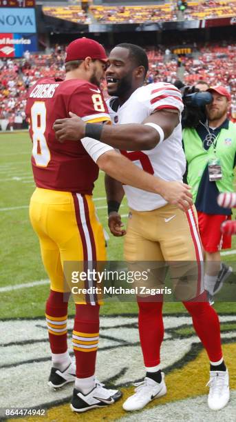 Kirk Cousins of the Washington Redskins and Pierre Garcon of the San Francisco 49ers embrace at midfield for the coin flip prior to during the game...