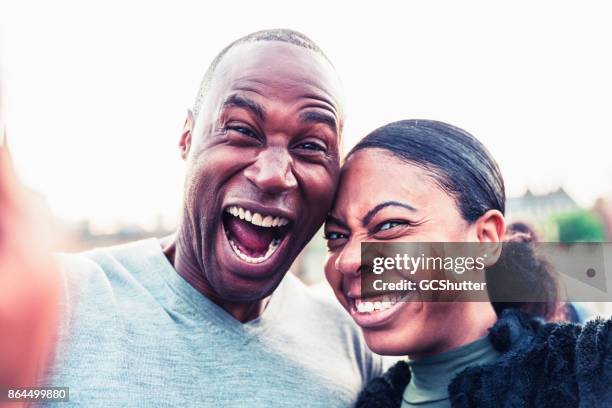 couple taking a selfie during their visit to london - big ben clock face stock pictures, royalty-free photos & images