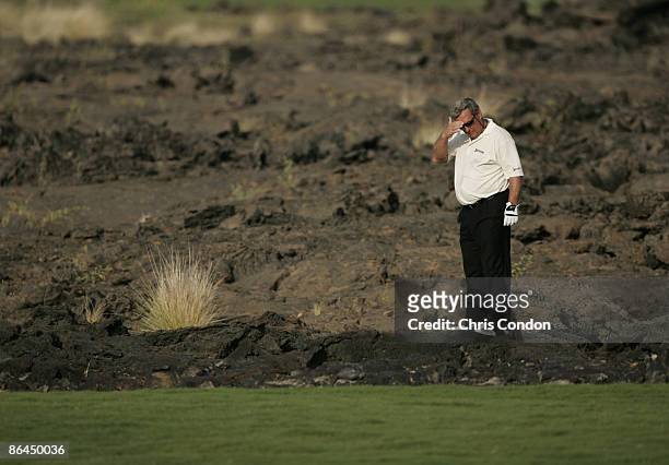 Fuzzy Zoeller looks for his ball in the lava during the second round of the 2006 Mastercard Championship at Hualalai resort, Kona, Hawaii. January...