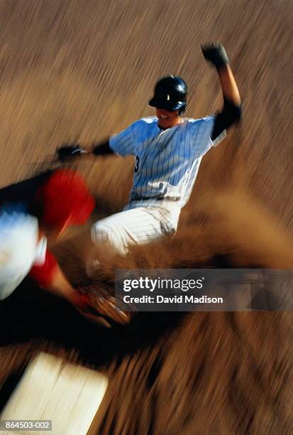 baseball, player sliding into third base (blurred motion) - southern european descent stockfoto's en -beelden