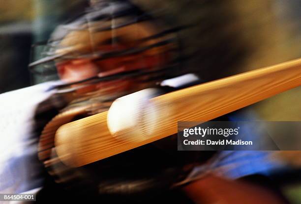 baseball, bat hitting ball, catcher standing behind (blurred motion) - baseball bat stock-fotos und bilder