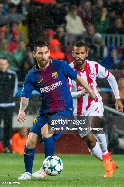 Lionel Andres Messi of FC Barcelona is followed by Alaixys Romao of Olympiacos FC during the UEFA Champions League 2017-18 match between FC Barcelona...