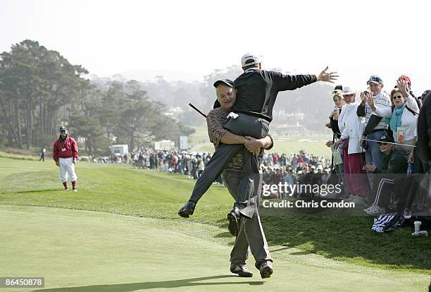 Bill Murray carries Jeff Sluman to the next tee during the third round of the AT&T Pebble Beach National Pro-Am on Pebble Beach Golf Links in Pebble...