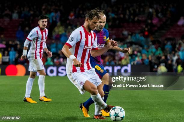 Guillaume Gillet of Olympiacos FC fights for the ball with Andres Iniesta Lujan of FC Barcelona during the UEFA Champions League 2017-18 match...