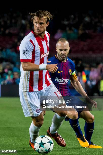 Guillaume Gillet of Olympiacos FC fights for the ball with Andres Iniesta Lujan of FC Barcelona during the UEFA Champions League 2017-18 match...