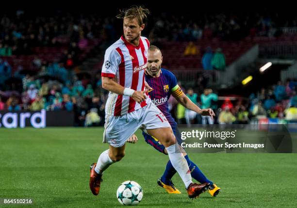 Guillaume Gillet of Olympiacos FC fights for the ball with Andres Iniesta Lujan of FC Barcelona during the UEFA Champions League 2017-18 match...