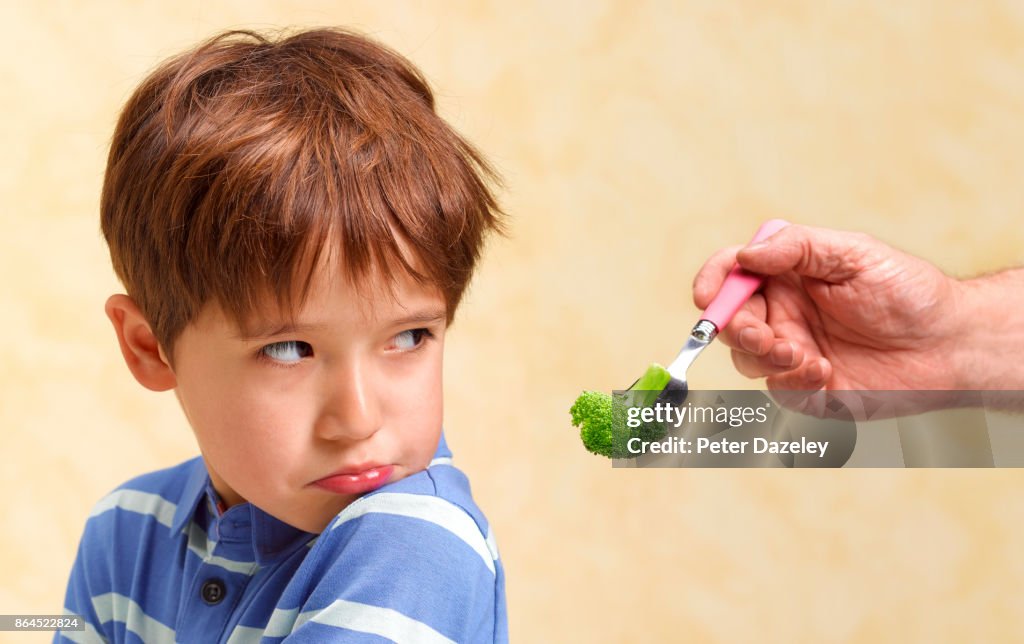 BOY REFUSING TO EAT HIS VEGETABLES