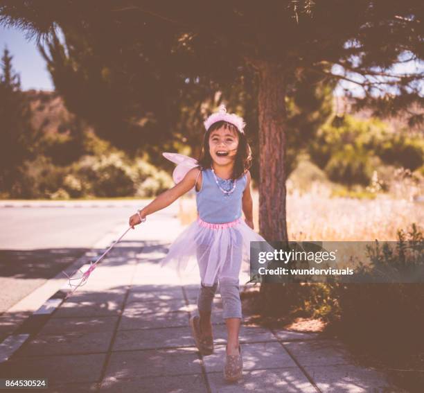 little asian girl playing dress-up in a fairy queen costume - saia de bailarina imagens e fotografias de stock