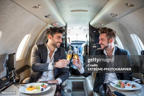 businessmen in private jet airplane - private airplane stock pictures, royalty-free photos & images