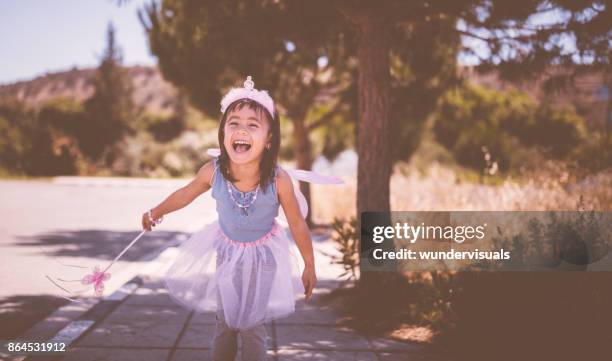 sweet little asian girl having fun outdoors in fairy queen costume - girl princess stock pictures, royalty-free photos & images