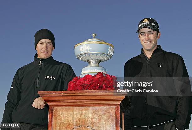 Henrik Stenson and Geoff Ogilvy pose with the trophy during the Championship match of the WGC-Accenture Match Play Championship held at The Gallery...