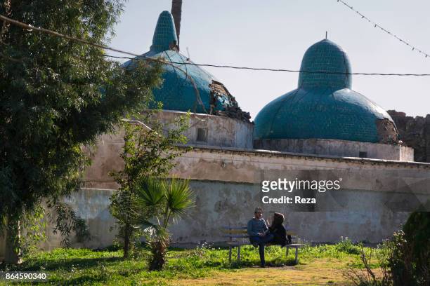 Couple in the garden of prophet Daniel's mausoleum , who is supposedly burried here. Important location of pilgrimage for muslims, often visited by...