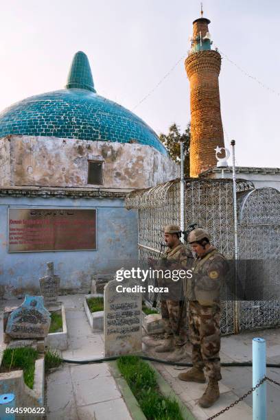 Peshmerga pray inside prophet Daniel's mausoleum who is supposedly burried here. Important location of pilgrimage for muslims, often visited by...
