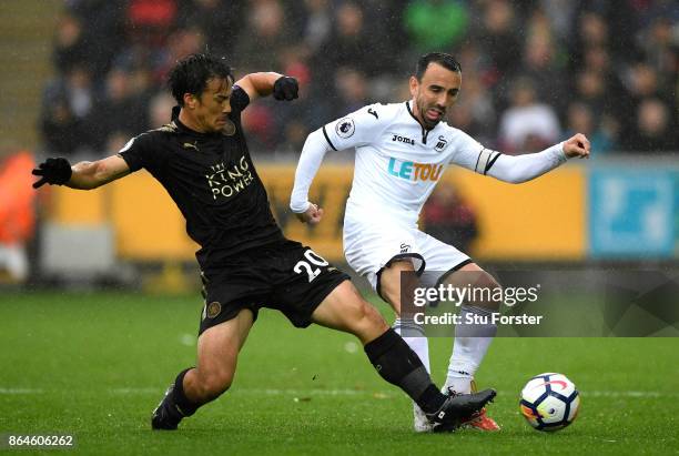 Jamie Vardy of Leicester City is tackled by Leon Britton of Swansea City during the Premier League match between Swansea City and Leicester City at...