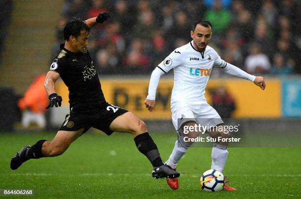 Jamie Vardy of Leicester City is tackled by Leon Britton of Swansea City during the Premier League match between Swansea City and Leicester City at...