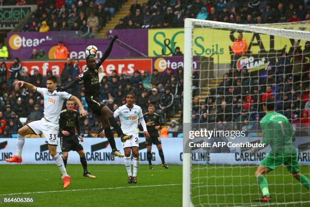 Leicester City's Nigerian midfielder Wilfred Ndidi wins a header from Swansea City's Argentinian defender Federico Fernandez but Swansea City's...
