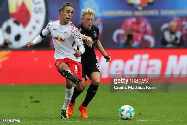 Yussuf Poulsen of Leipzig battles for the ball with Andreas Beck of Stuttgart during the Bundesliga match between RB Leipzig and VfB Stuttgart at Red...
