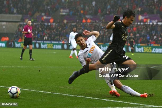 Swansea City's Argentinian defender Federico Fernandez vies with Leicester City's Japanese striker Shinji Okazaki during the English Premier League...