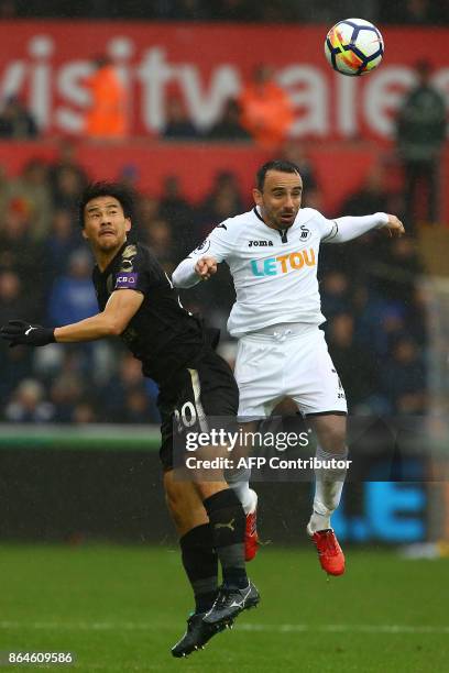 Leicester City's Japanese striker Shinji Okazaki vies with Swansea City's English midfielder Leon Britton during the English Premier League football...