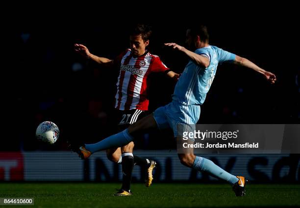 Lasse Vibe of Brentford tackles with John O'Shea of Sunderland during the Sky Bet Championship match between Brentford and Sunderland at Griffin Park...