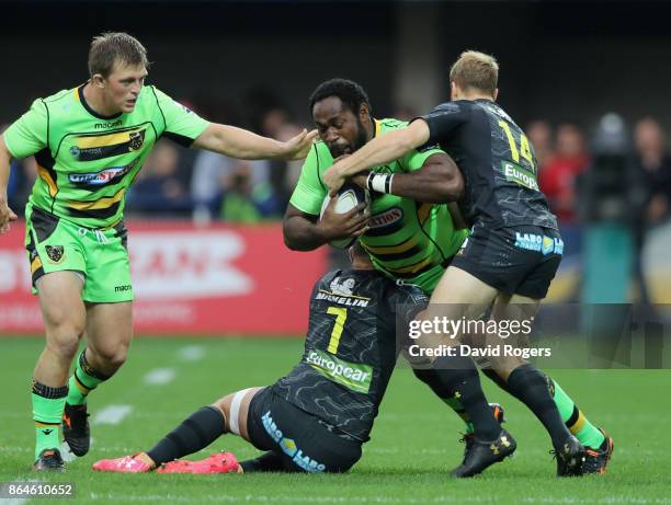 Jamal Ford-Robinson of Northampton is tackled by Nick Abendanon and Alexandre Lapandry during the European Rugby Champions Cup match between ASM...