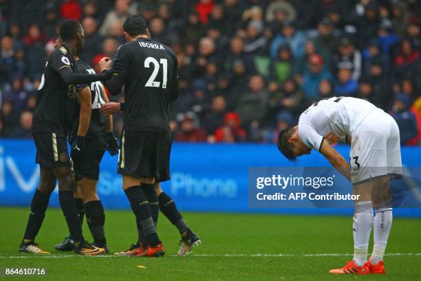 Leicester players celebrate as Swansea City's Argentinian defender Federico Fernandez reacts after putting the ball into his own net during the...