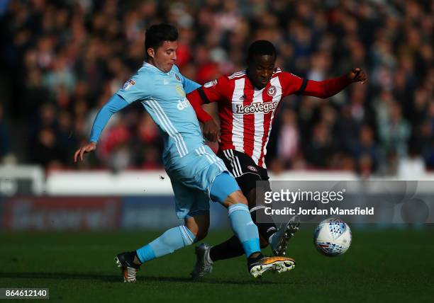 Brian Oviedo of Sunderland tackles with Florian Jozefzoon of Brentford during the Sky Bet Championship match between Brentford and Sunderland at...