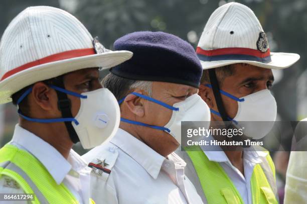 Gurgaon traffic policemen wear N95 Anti-Pollution mask distributed by a private hospital, due to increase pollution level, on October 21, 2017 in...
