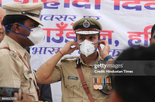 Gurgaon Police Commissioner Sandeep Khiwar wears N95 anti-pollution mask distributed by a private hospital, due to increase pollution level, on...