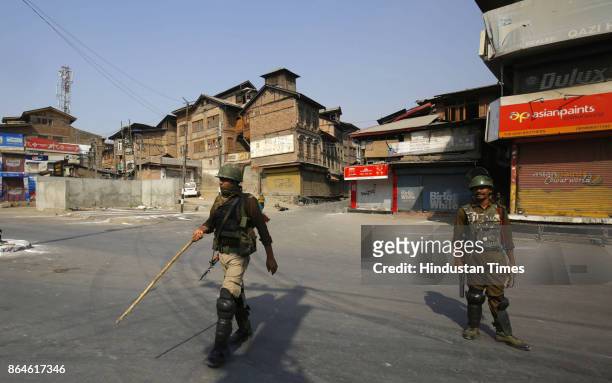 Paramilitary soldiers stand guard during a restriction in downtown area on October 22, 2017 in Srinagar, India. Authorities imposed restrictions in...