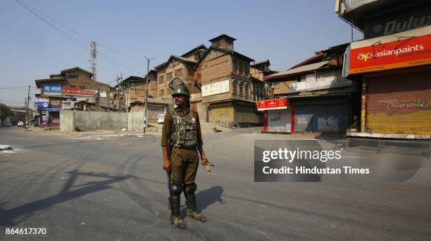 Paramilitary soldiers stand guard during a restriction in downtown area on October 22, 2017 in Srinagar, India. Authorities imposed restrictions in...