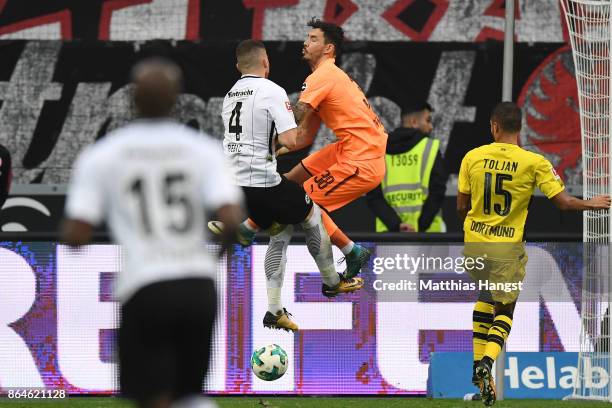 Goalkeeper Roman Buerki of Dortmund fouls Ante Rebic of Frankfurt which results in a penalty for Frankfurt during the Bundesliga match between...