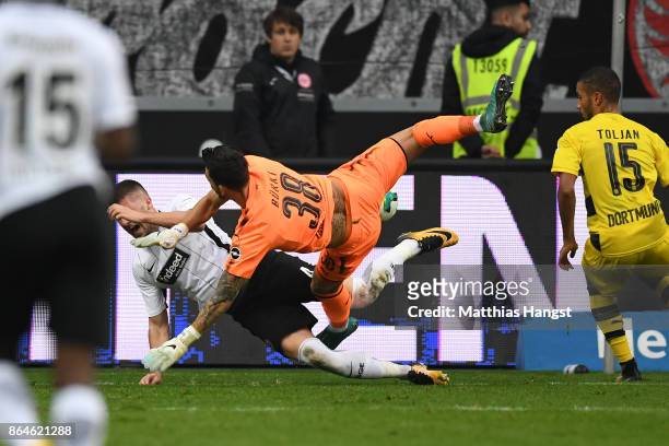 Goalkeeper Roman Buerki of Dortmund fouls Ante Rebic of Frankfurt which results in a penalty for Frankfurt during the Bundesliga match between...