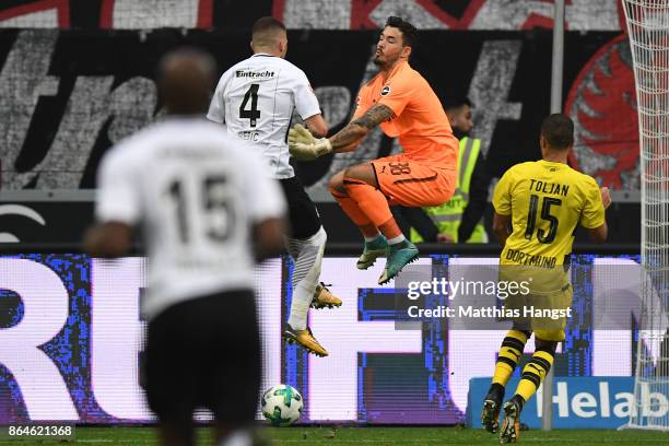 Goalkeeper Roman Buerki of Dortmund fouls Ante Rebic of Frankfurt which results in a penalty for Frankfurt during the Bundesliga match between...