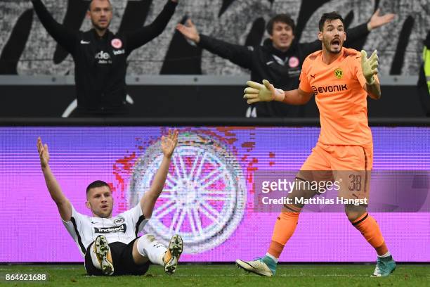 Ante Rebic of Frankfurt lies on the pitch after a foul by goalkeeper Roman Buerki of Dortmund which resulted in a penalty for Frankfurt during the...