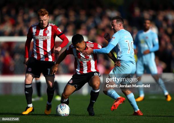 Nico Yennaris of Brentford tackles with Aiden McGeady of Sunderland during the Sky Bet Championship match between Brentford and Sunderland at Griffin...