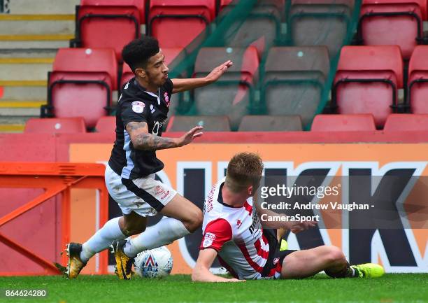 Lincoln City's Josh Ginnelly vies for possession with Cheltenham Town's Taylor Moore during the Sky Bet League Two match between Cheltenham Town and...