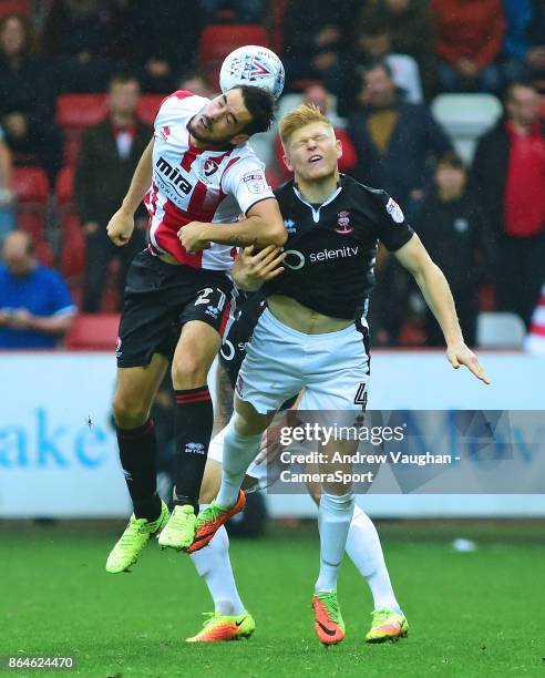 Lincoln City's Elliott Whitehouse vies for possession with Cheltenham Town's Brian Graham during the Sky Bet League Two match between Cheltenham Town...