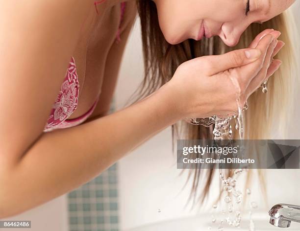teenage girl washing face - girls in bras photos bildbanksfoton och bilder