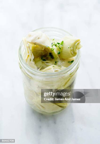jar of marinated artichoke hearts - preserved in oil stock pictures, royalty-free photos & images